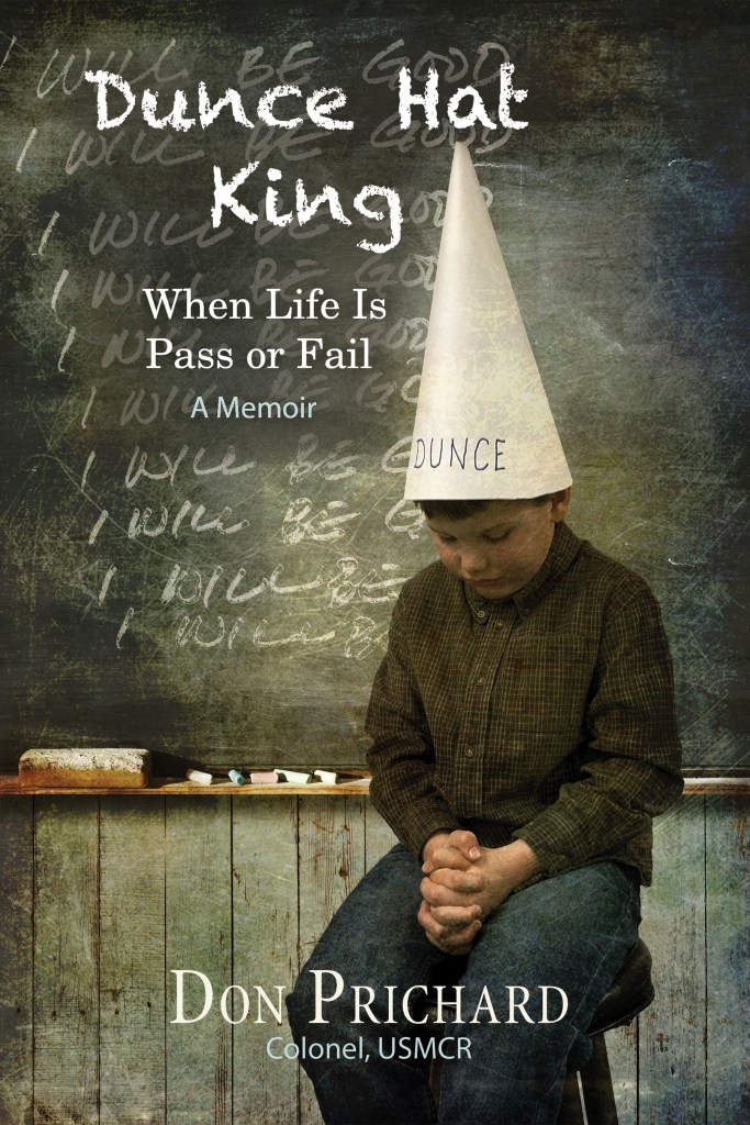 Cover of Dunce Hat King by Don Prichard shows child sitting at front of class wearing dunce hat